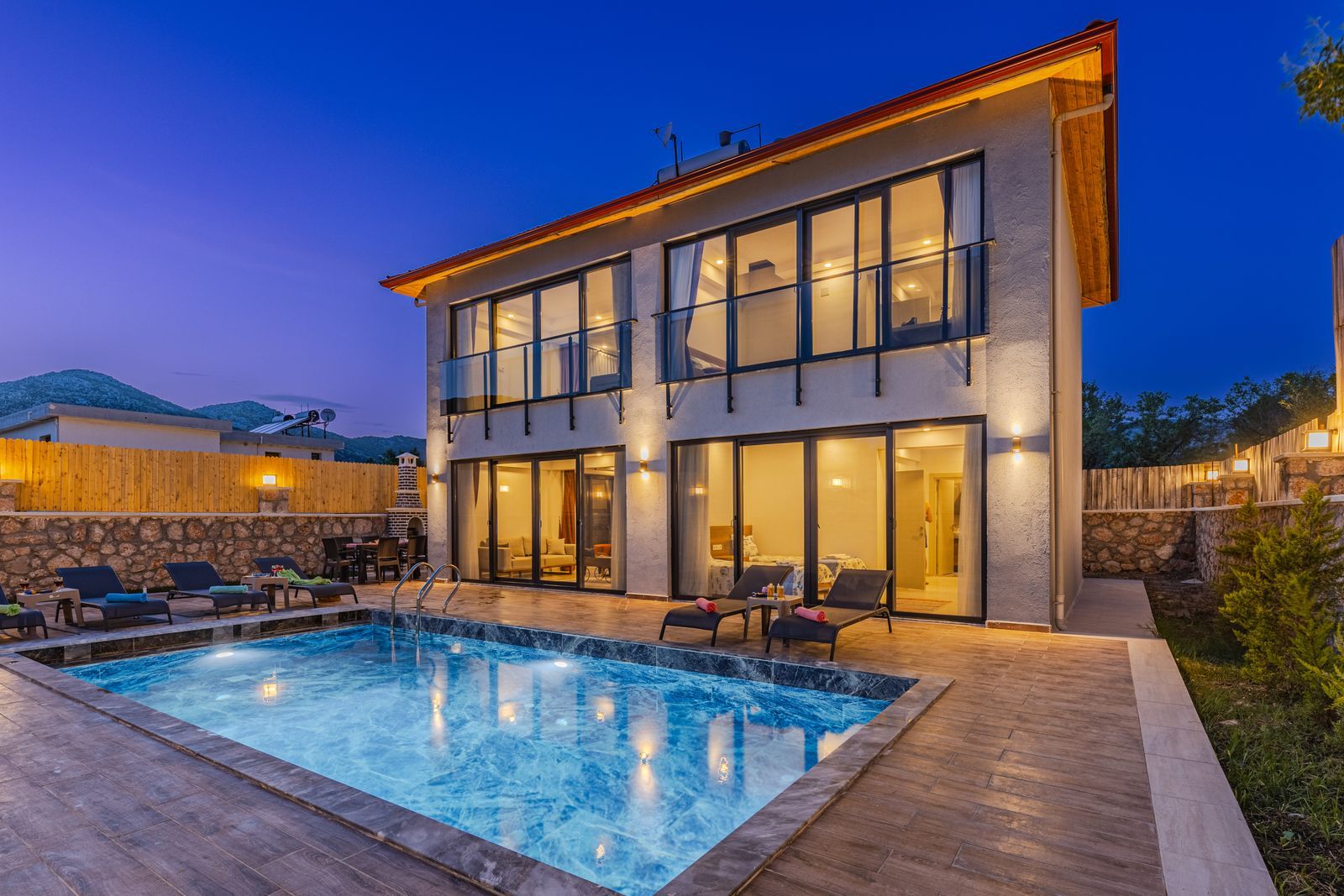 A modern house with a pool at dusk