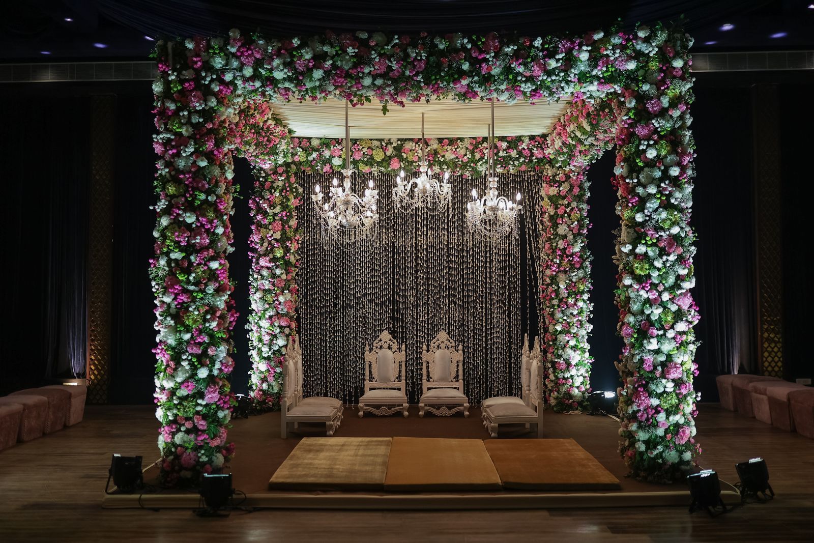 A floral mandap at night