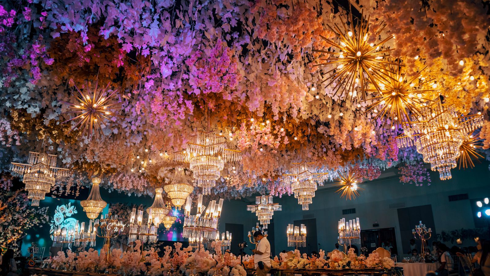 A venue ceiling filled with flowers and lights