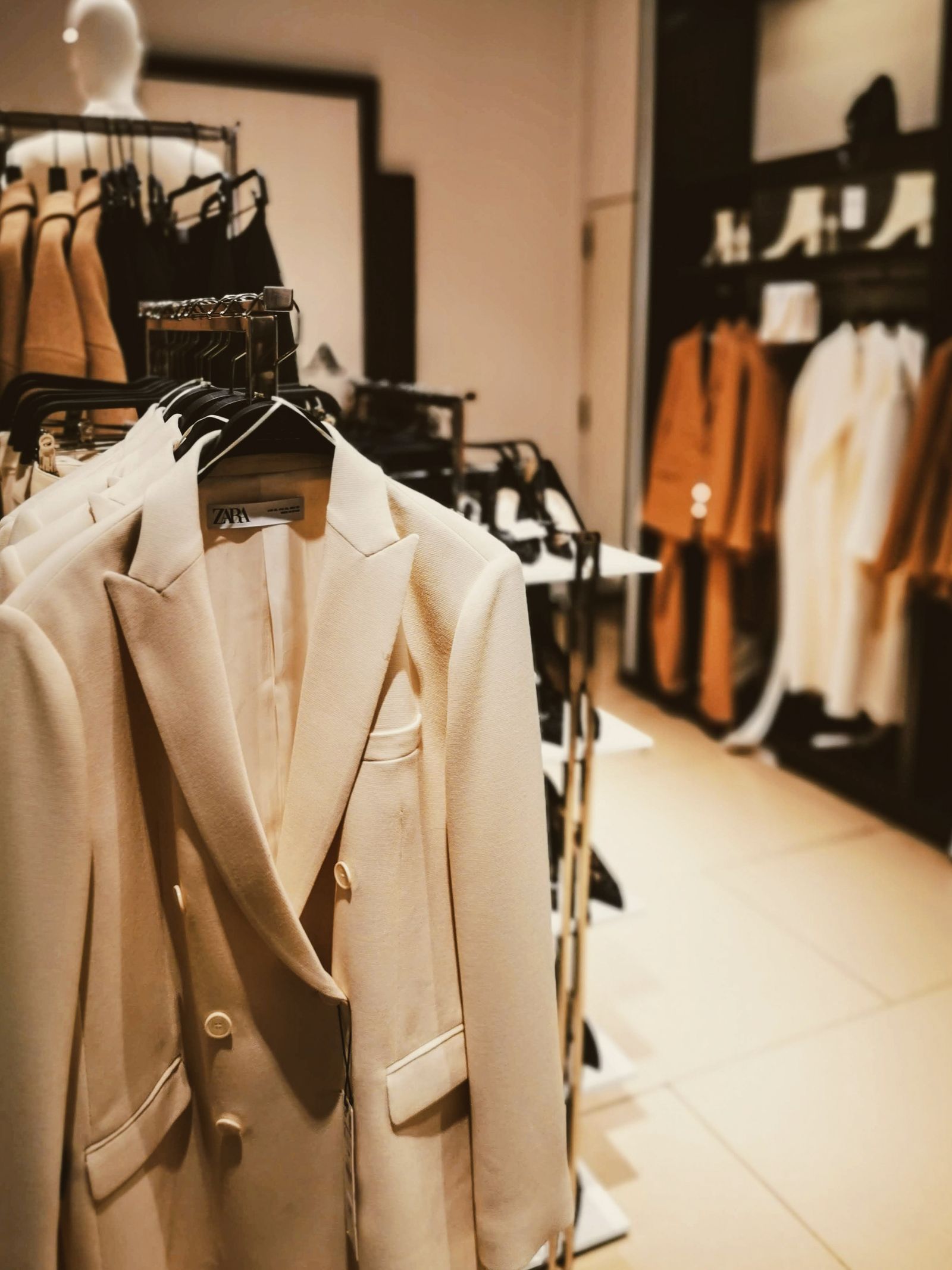Beige suits displayed in a fashion store